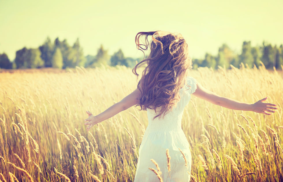 woman running through long grass at sunset with hair flowing in wind. for the 5 principals of Usui traditional japanese reiki by caroline mcelwee, reiki master teacher dublin. for reiki healing and reiki workshops