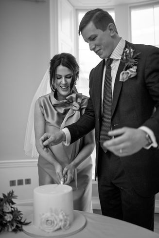 bride and groom cutting wedding cake