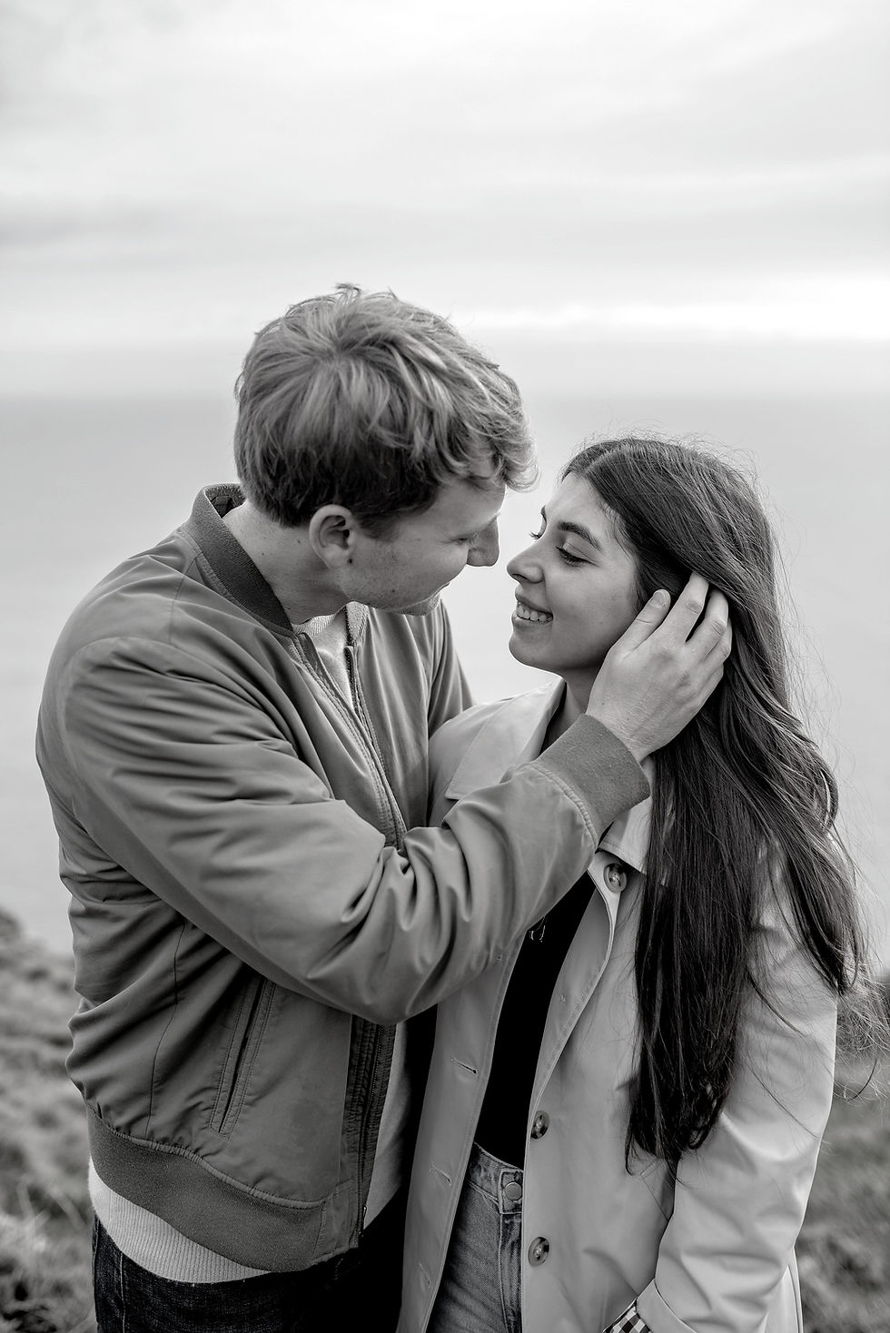 couple in intimate moment by the sea overlooking cliffs in Howth, dublin