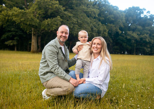 mum, dad, baby boy kneeling in grass for family portrait, Phoenix Park