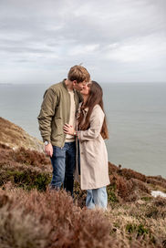 kissing on the heather on a cliff-surprise proposal kiss