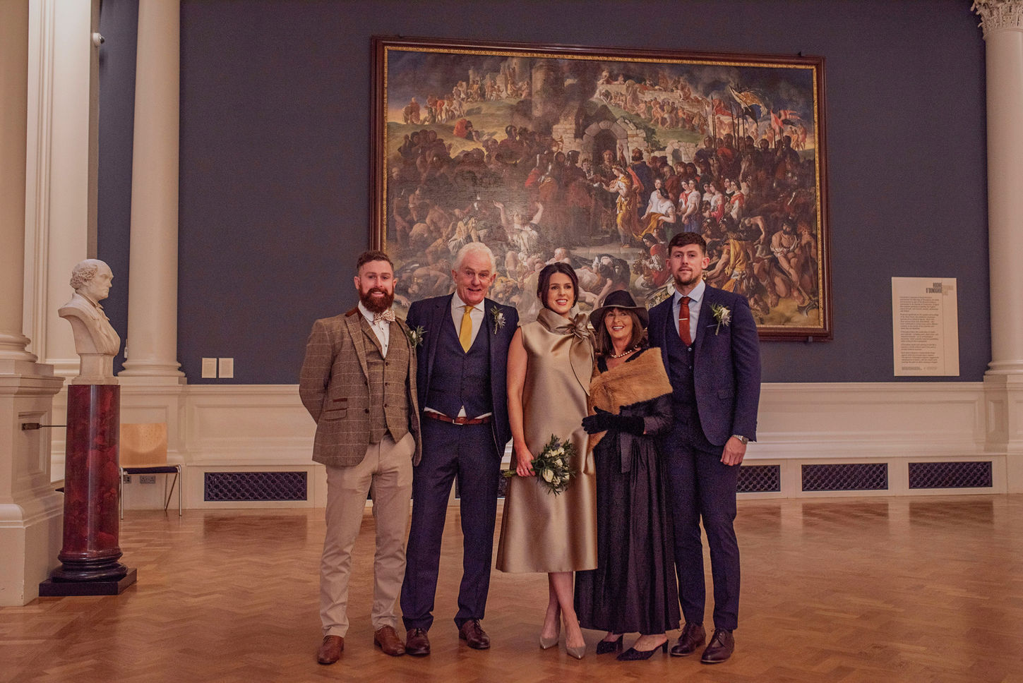 family gathered for a traditional wedding portrait in national portrait gallery main portrait room