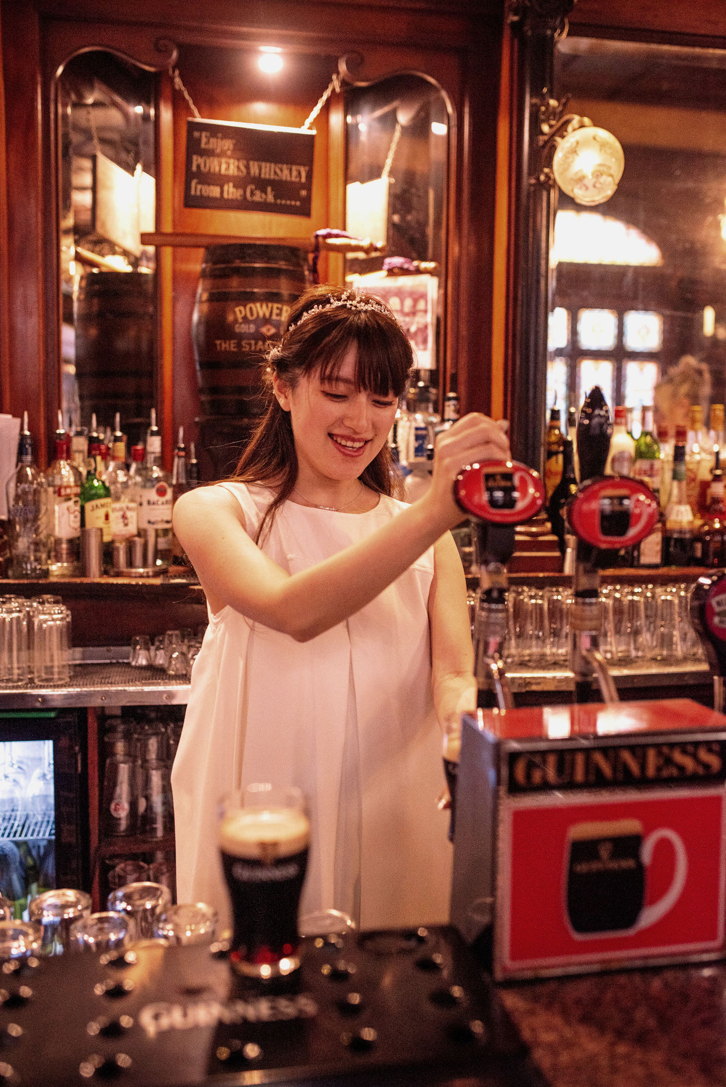 bride pulling pints in Stag's Head pub