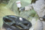 Automobile disc restoring. Painter painting light alloy wheel with spray.jpg
