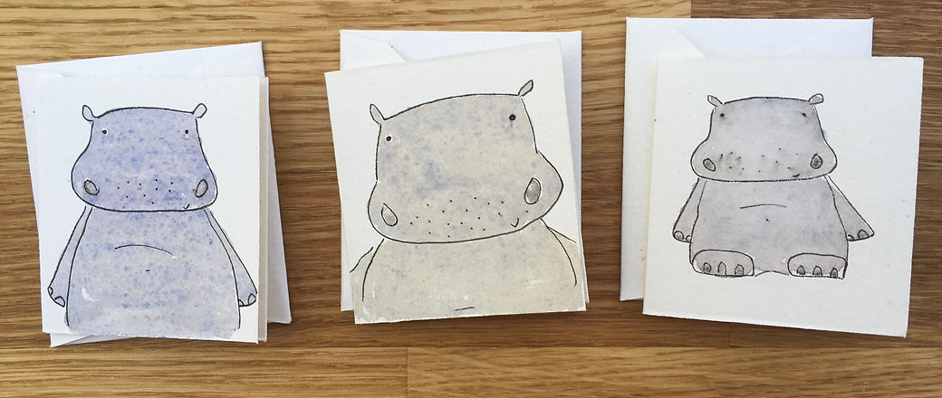 artwork showing three cartoon hippos