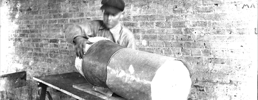 Mattress factory worker unpacking mattress material