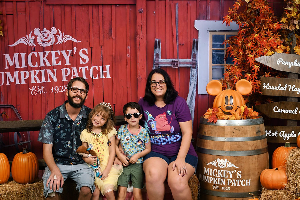 Family at Disney Springs Pumpkin Patch photo op