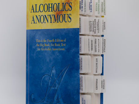 Tabbed and highlighted AA Big Book, three-quarter front view