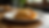 Eye-level view of a golden empanada on a plate