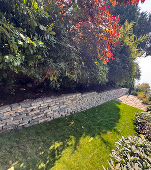 Stacked stone retaining wall along new lawn, Greater Victoria BC