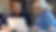 two coworkers looking at a shared laptop screen