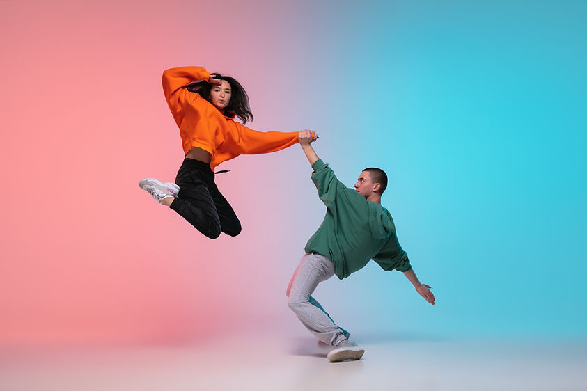 In jump. Boy and girl dancing hip-hop in