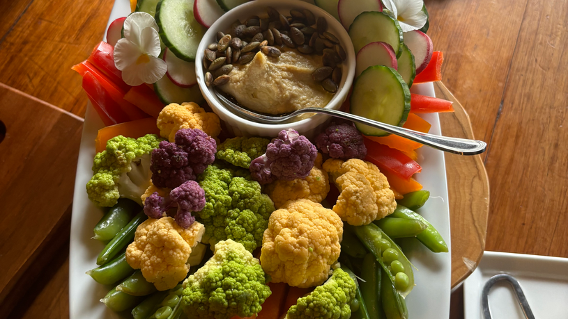 Vegetable tray with seasonal produce and fresh hummus