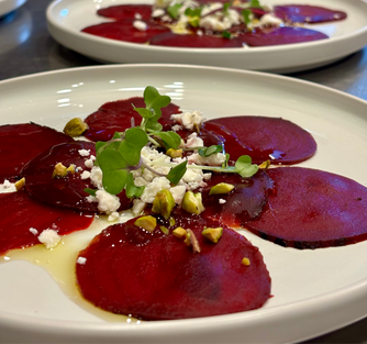 Beet carpaccio with pistachios, feta, and honey