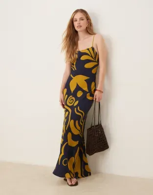 model wearing black and yellow sundress