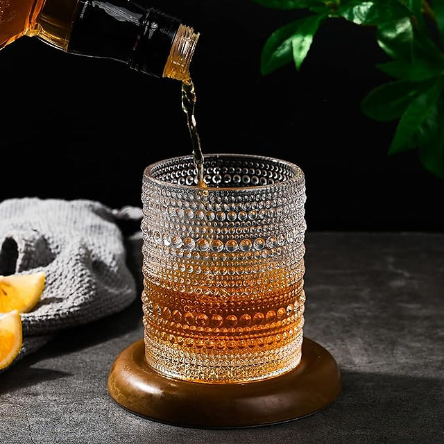 drink being poured into cocktail glass