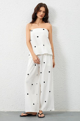 girl in white and black polka dot outfit
