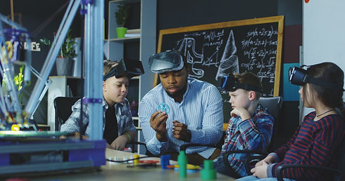 teacher with group of kids having lesson about 3d modeling wearing VR glasses in lab..jpg