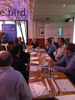 Group of people sat around a table at a networking event