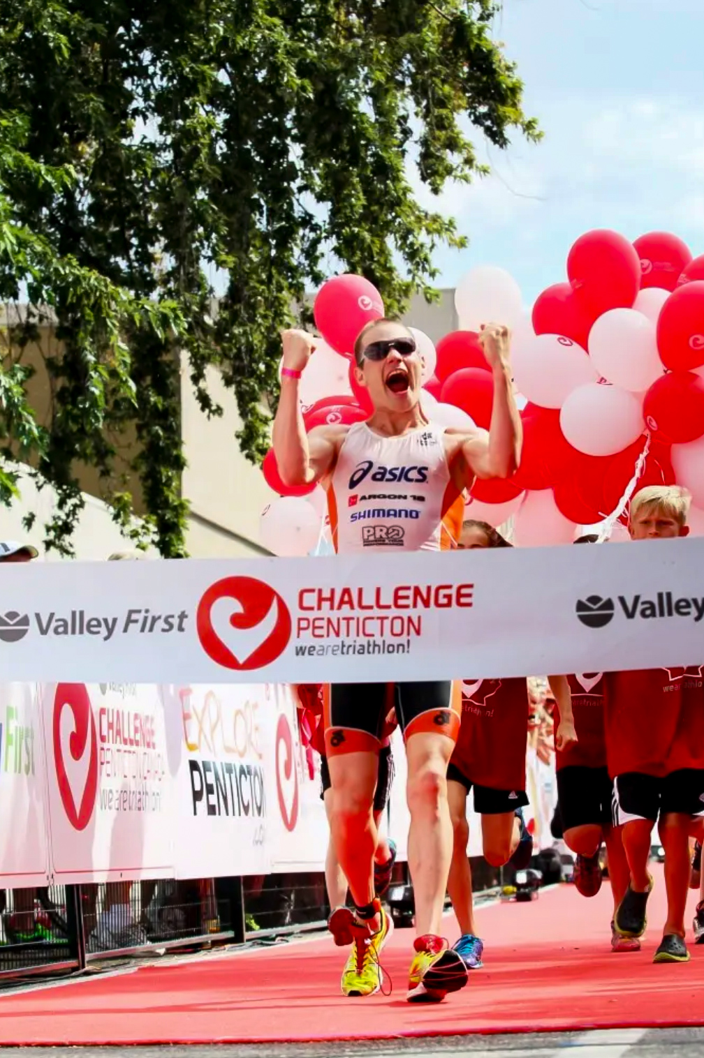 Triathlete celebrating at the Challenge Penticton race finish line