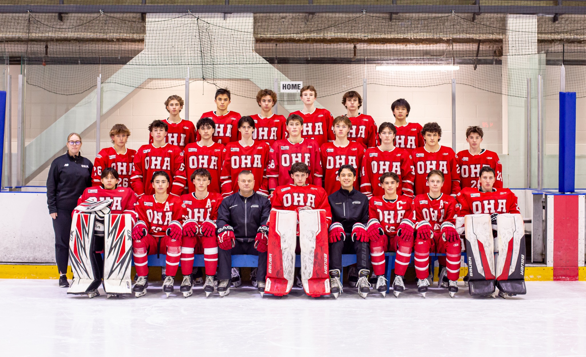Full youth ice hockey team in red OHA jerseys photographed on the rink
