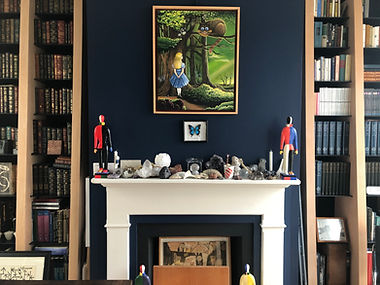 Image of a fireplace at the Peter Bullough Foundation with a painting depicting Alice in Wonderland