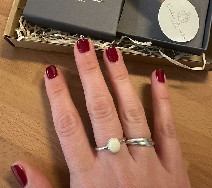 A round breastmilk ring being worn