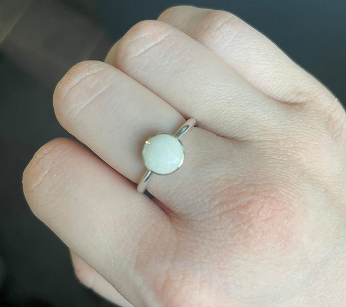 Silver breastmilk ring on finger