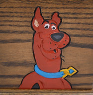 close up of scooby doo carving on wood urn