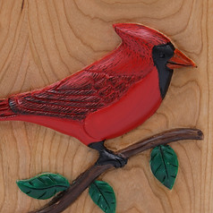 close up of cardinal bird on red cardinal cremation urn