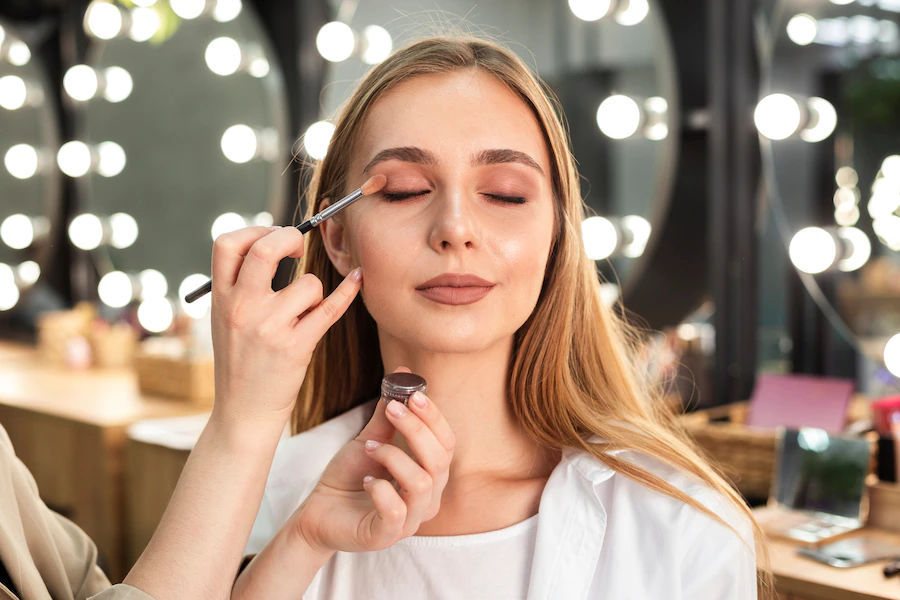 make-up-artist-applying-eyeshadow-woman_23-2148332525.webp