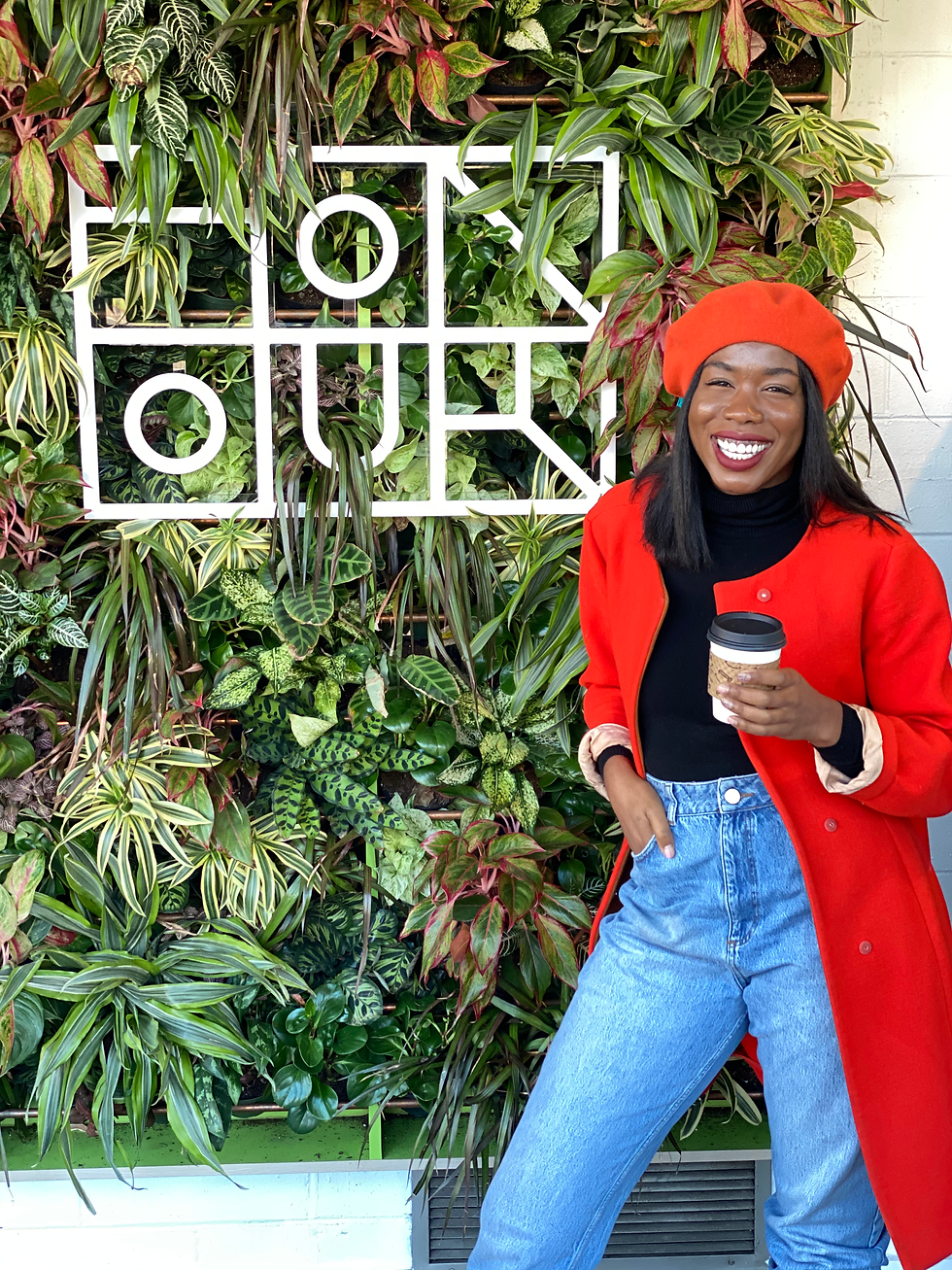 Shayla in front of a living plant wall at Honour Cafe in Minneapolis