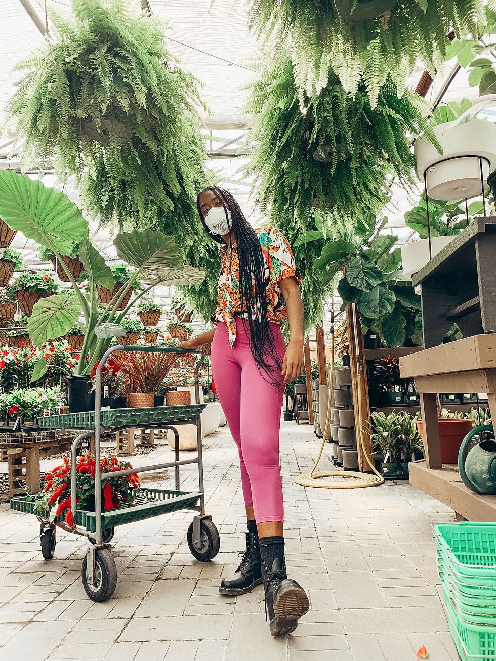Shayla with a cart of plants at Tonkadale Greenhouse