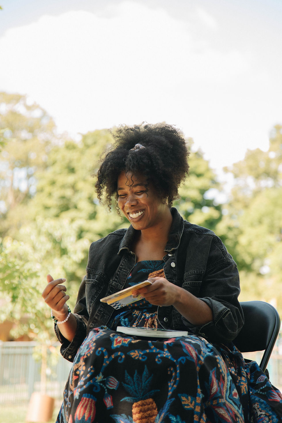 Shayla reading a children's book in the park
