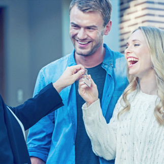 Couple getting keys to a house, buying a house, closing on a house.