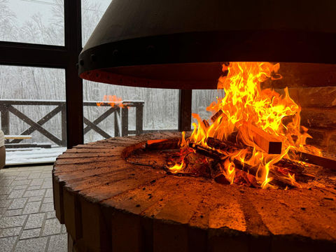 Open fire in the guest lounge area of Yama Lodge, Madarao