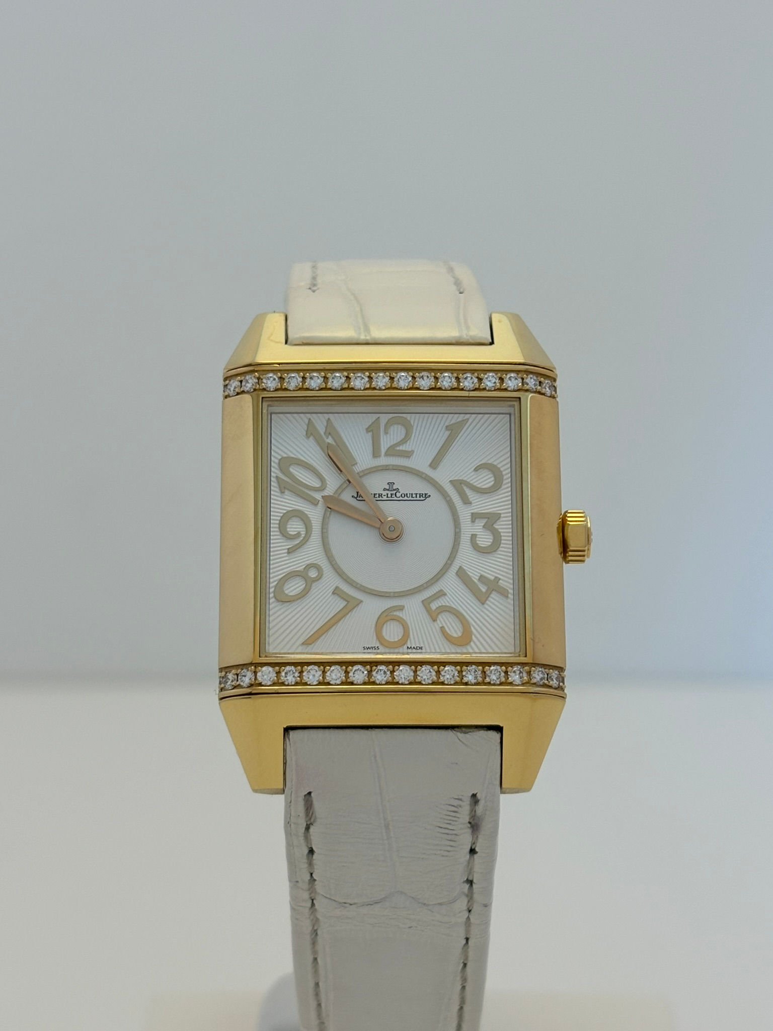 Jaeger-LeCoultre Reverso Squadra Lady in yellow gold with reversible square case and diamond accents.
