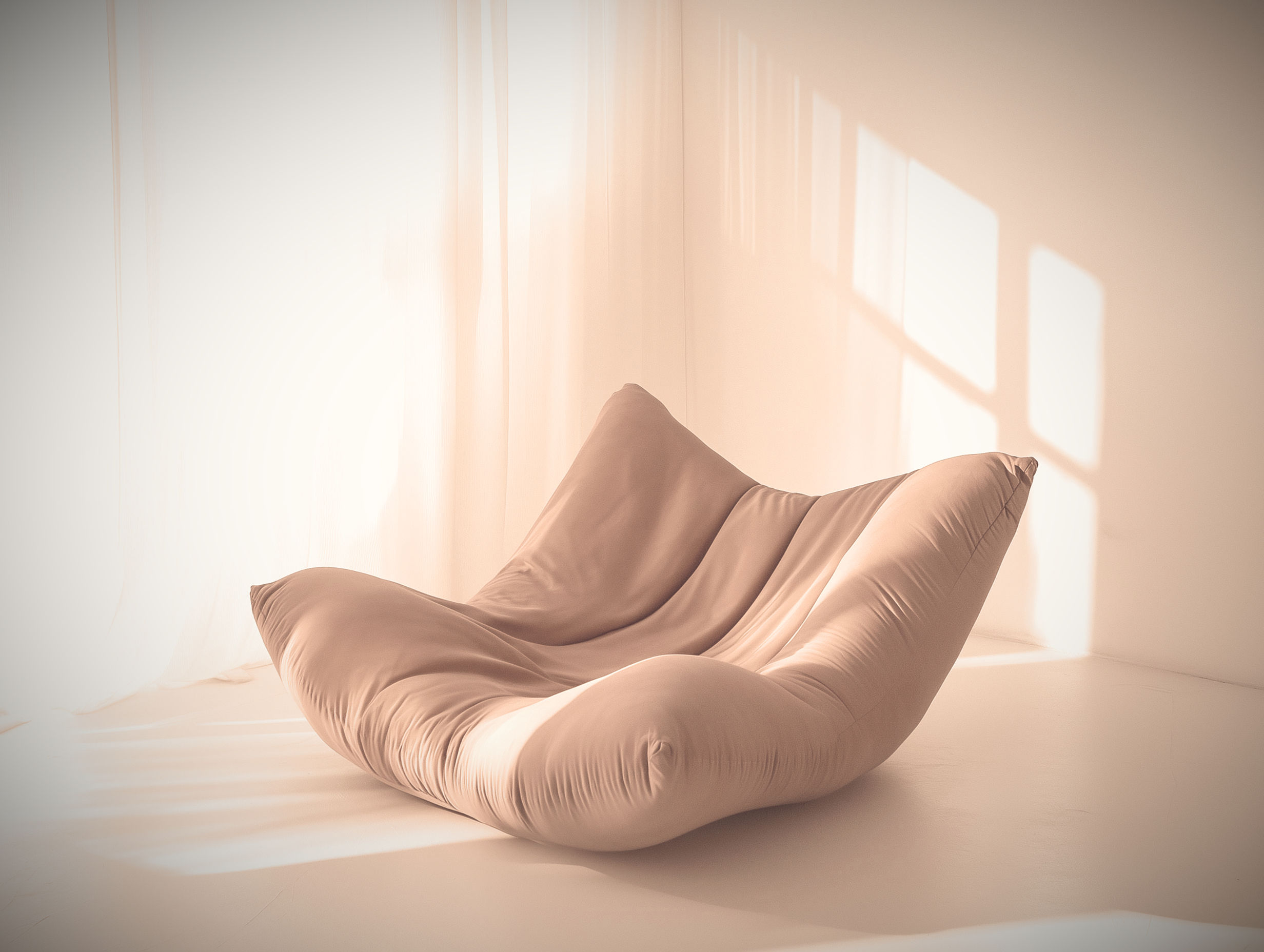 Plush beige lounge chair in bright room with sun-dappled floor.