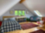 Interior living space of studio apartment Dragon Nest with double bed and sofa
