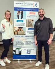 Two people standing next to Roll-up Banner with Service Information 