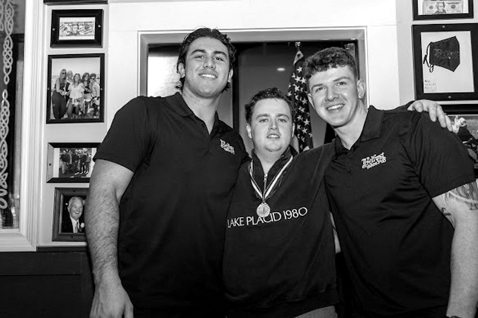 Three team members standing together indoors, landscape photo, suitable for security guard service team showcase, landscape
