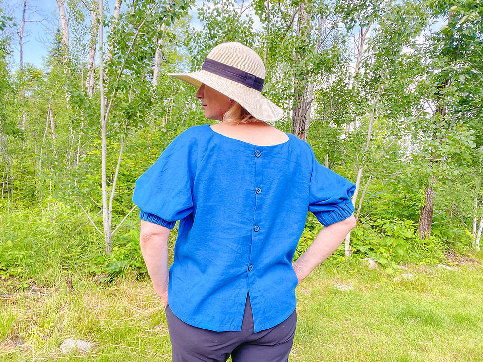 Sewing instructor wearing a blue button-back linen top.