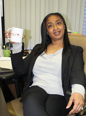 headshot behind desk with cup.jpg