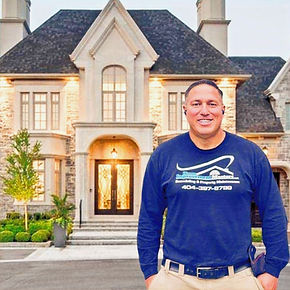 Craig Champagne Owner/Operator Standing in Front of Luxury Custom Built Home