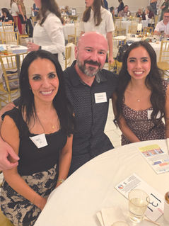 family members pose at dinner together