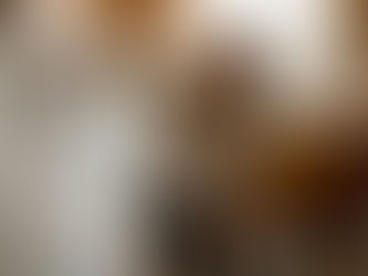 Woman deep cleaning top of kitchen fridge