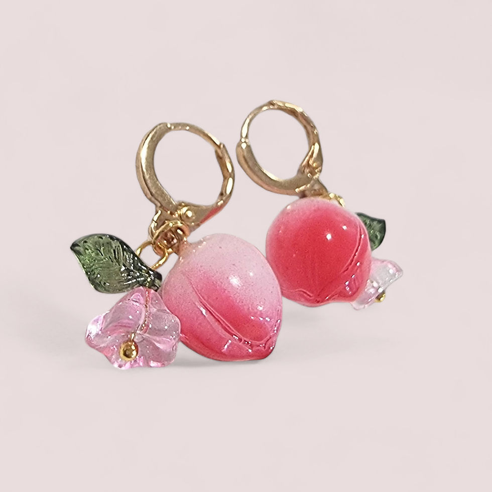 Thumbnail: Pink glass peach fruit huggie hoop earrings with green leaves and a small flower charm.