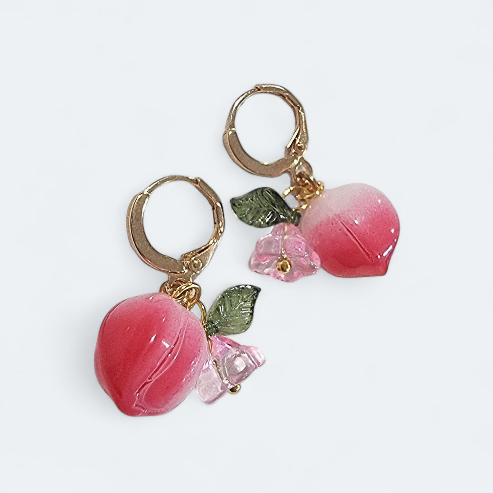 Thumbnail: Pink glass peach fruit huggie hoop earrings with green leaves and a small flower charm.