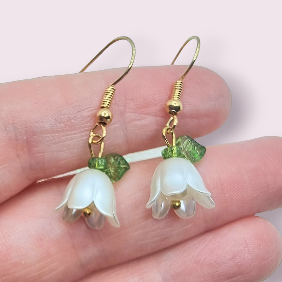 Thumbnail: Delicate white translucent Lilly of the Valley flower dangle earrings with green leaves on silver hooks.