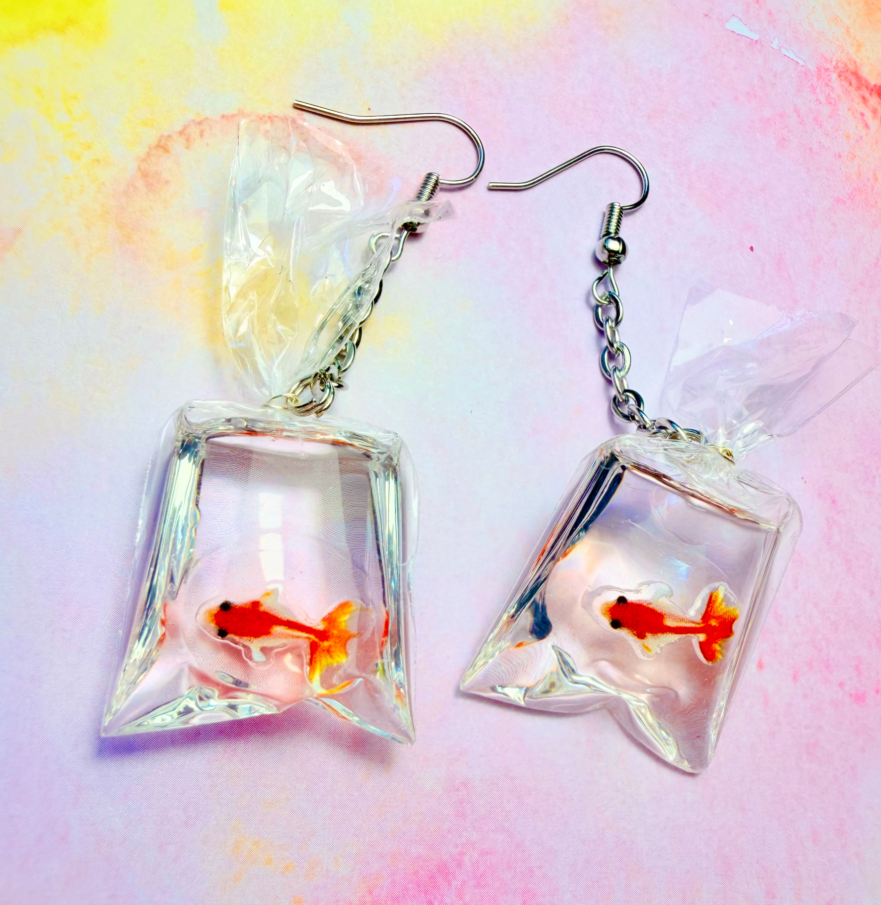 Quirky miniature goldfish in a water bag drop earrings on silver hooks